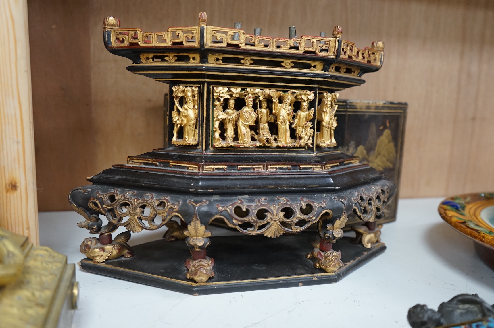 A Chinese lacquered and carved wood temple ornament, 26.5cm high, 32cm widest on base.